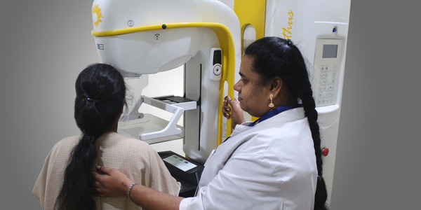 Female doctor guiding a patient to set in the right position to get the mammogram done in the Anderson diagnostic centre