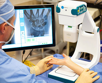 Doctor checking patient hand with x ray machine